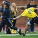Gaspare Calandrino attempts to escape the reach of Chris Bohn during the Victors Classic alumni football game at Michigan Stadium on Saturday. Melanie Maxwell I AnnArbor.com